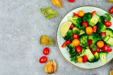 Photo for Fresh salad with broccoli, tomato, cucumber and physalis. Copy space - Royalty Free Image