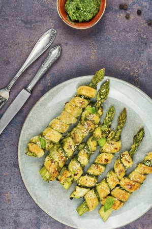 Photo for Asparagus baked in puff pastry with pesto sauce. Veggie, healthy food. Flat lay. - Royalty Free Image