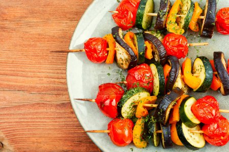 Photo for Grilled skewers vegetables on old wooden table, vegan food. Space for text. Flat lay. - Royalty Free Image