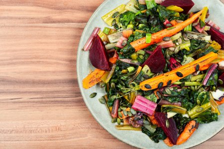 Photo for Dietary delicious vegetarian food - stewed swiss chard, beets and carrots. Copy space - Royalty Free Image