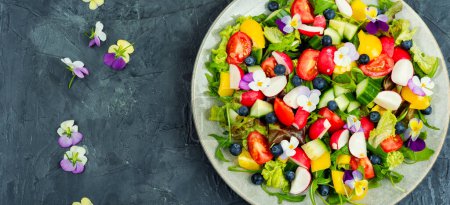 Photo for Spring colorful salad with vegetable and edible flowers. Healthy food. Copy space. - Royalty Free Image
