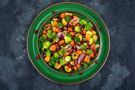 Photo for Dietary salad of boiled brussels sprouts, greens and physalis on a concrete kitchen table. Vegan colorful salad. Top view - Royalty Free Image
