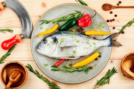 Photo for Uncooked dorado fish with ingredients for cooking on rustic wooden background - Royalty Free Image