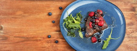 Photo for Delicious beef steak cooked with blueberry and raspberry sauce. Grilled meat medallions. Copy space, long banner. - Royalty Free Image