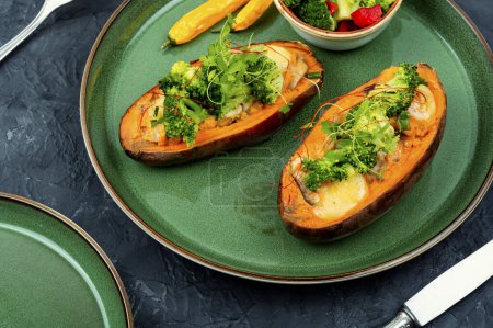 Photo for Baked sweet potato stuffed with mushrooms, broccoli and peppers. Vegan food - Royalty Free Image