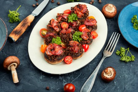 Photo for Delicious champignon mushrooms caps stuffed with minced meat and bacon. - Royalty Free Image