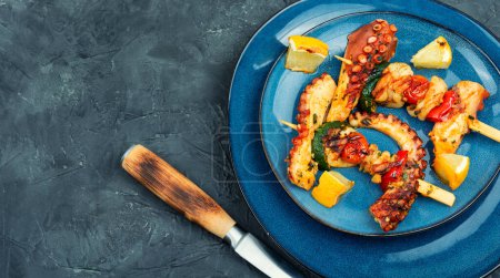 Photo for Grilled octopus on wooden skewers, grilled octopus.Copy space. - Royalty Free Image
