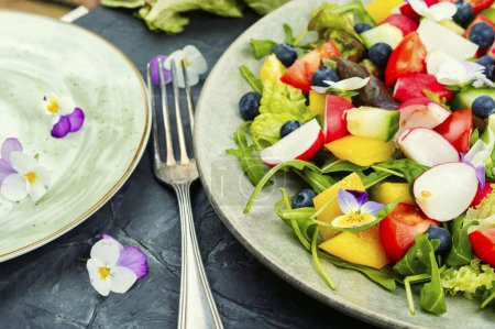 Foto de Ensalada de verduras saludables con flores comestibles. Comida limpia, cetogénica. - Imagen libre de derechos