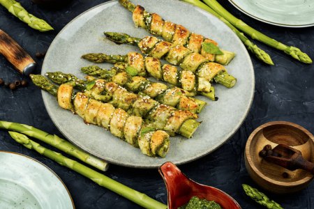 Photo for Veggie green asparagus baked in puff pastry with pesto sauce.Healthy eating. - Royalty Free Image
