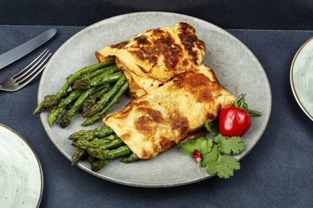 Photo for Freshly made omelette cooked with green asparagus for breakfast - Royalty Free Image
