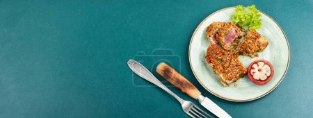 Photo for Steak of baked tuna in a nut panic with a mangosteens. Copy space, long banner. - Royalty Free Image