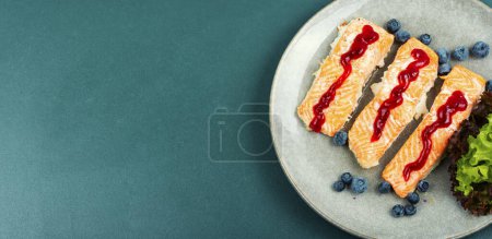 Photo for Fried salmon fillet with blueberry berry sauce. Healthy food. Space for text. - Royalty Free Image
