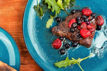 Photo for Fried beef fillet medallion steak with berry sauce on the table. Barbecue. - Royalty Free Image