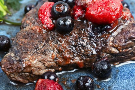 Photo for Delicious grilled meat medallions with berries sauce. Close up. - Royalty Free Image