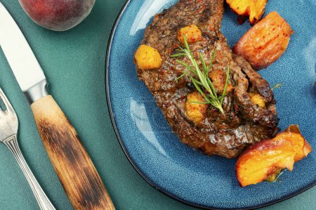 Photo for Diet beef steak roasted with peach on a plate. - Royalty Free Image