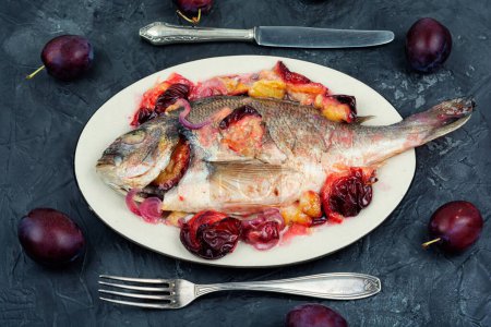 Photo for Dorado or sea bream fish roasted with plums. Top view - Royalty Free Image