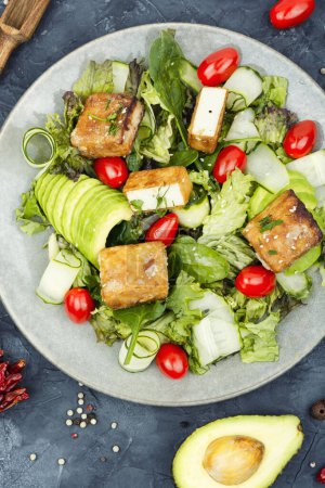 Photo for Tasty salad with roasted cheese tofu, vegetables and herbs, dieting. - Royalty Free Image