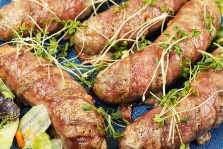 Photo for Fried sausage on plate, fast food. Barbecue bratwurst. Close-up. - Royalty Free Image