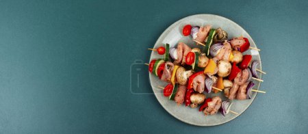 Téléchargez les photos : Kebab de viande non cuit appétissant avec des légumes marinés aux herbes. Espace de copie. - en image libre de droit