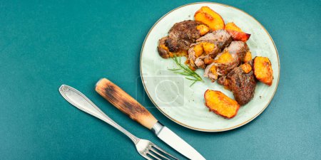 Photo for Diet baked veal steak with peach, space for text. - Royalty Free Image