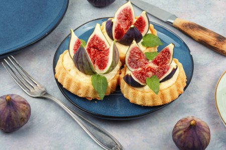 Photo for Small tartlet dessert with cream and figs on a gray concrete background. Summer fruit baking. - Royalty Free Image