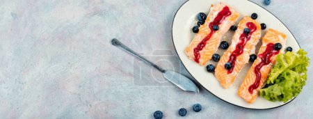 Photo for Baked salmon fish with blueberry berry sauce. Salmon fillets, grilled steaks. Panorama, copy space - Royalty Free Image