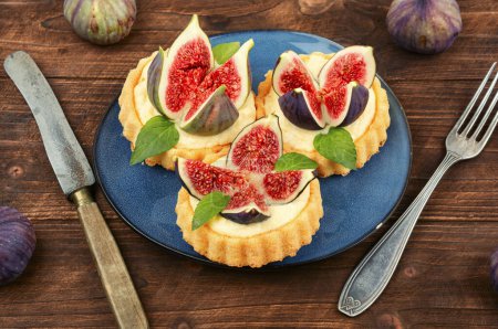 Photo for Berry tartlets dessert on wooden old table. Homemade sweet pastries. - Royalty Free Image