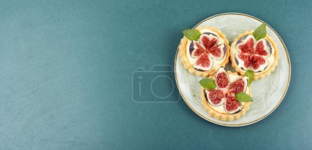 Photo for Small tartlet dessert with whipped cream and figs. Copy space. - Royalty Free Image