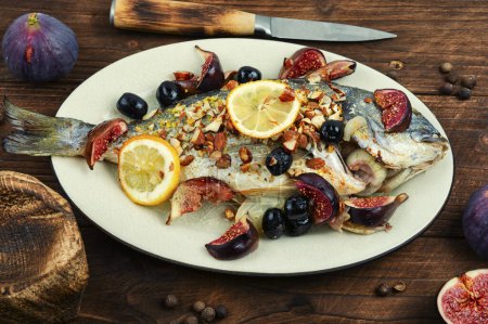 Photo for Baked dorado fish with garnish and figs. Autumn recipe. - Royalty Free Image