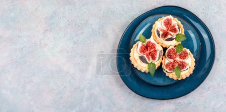 Photo for Small tartlet dessert with whipped cream and figs. Copy space. - Royalty Free Image