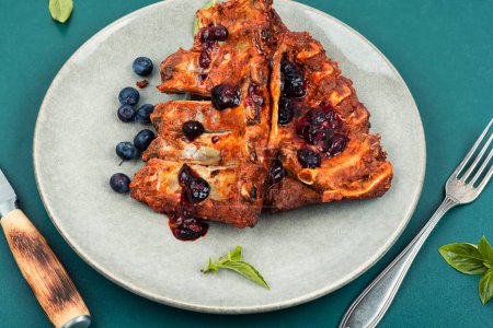 Photo for Fried spicy pork ribs with blueberry marinade or sauce. - Royalty Free Image