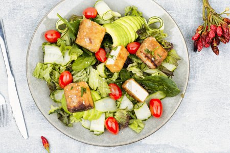 Photo for Unusual salad with roasted cheese tofu, vegetables and herbs - Royalty Free Image