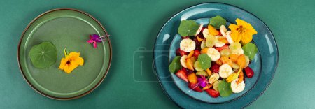 Photo for Yummy salad of fresh fruits and nasturtium leaves. Top view. - Royalty Free Image