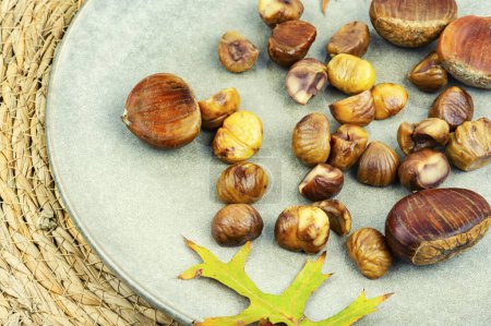 Photo for Peeled roasted chestnuts, appetizing dessert. Caramelized roasted chestnuts. - Royalty Free Image