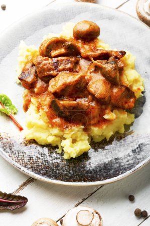 Photo for Appetizing beef stroganoff meat. Meat with mushrooms and mashed potatoes - Royalty Free Image