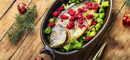 Photo for Dorado baked with raspberry marinade and brocooli. Fish for the Christmas table. - Royalty Free Image