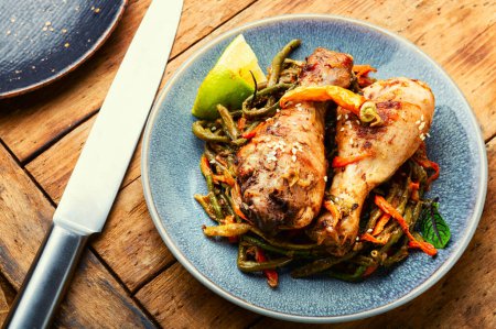Photo for Roasted chicken with vegetable garnish and spices. Braised spicy chicken legs. - Royalty Free Image