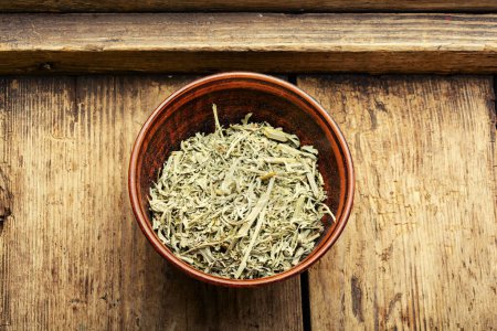 Photo for Alternative medicine, medicinal herbs. Wormwood in a mortar. - Royalty Free Image