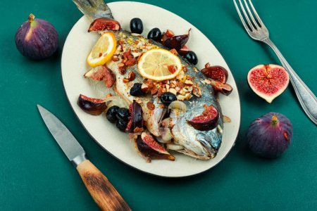 Photo for Whole grilled or baked dorado or dorada fish with almonds and figs. Autumn recipe. - Royalty Free Image