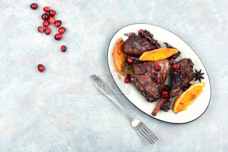 Photo for Chicken legs marinated in red wine, baked with orange and berries. Roasted chicken meat. Top view. Copy space. - Royalty Free Image