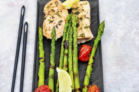 Photo for Grilled savoury salmon fillet with green asparagus. Healthy meal. - Royalty Free Image