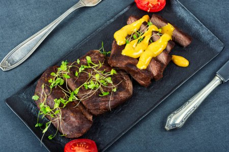 Photo for Delicious ostrich meat steaks with sauce. African cuisine. - Royalty Free Image