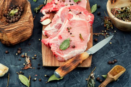 Photo for Raw pork steak, meat with seasoning on a kitchen wooden board. Meat. Entrecote. - Royalty Free Image