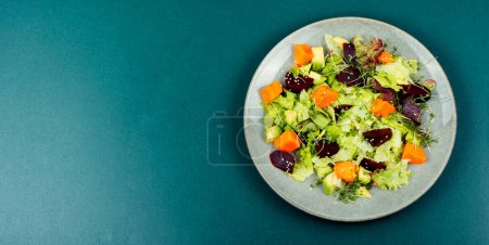 Photo for Autumn vegetarian salad of baked pumpkin, beetroot and greens. Top view with copy space. - Royalty Free Image