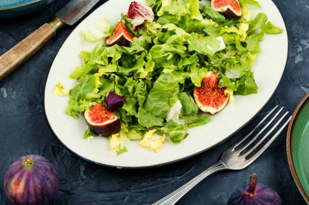 Photo for Colorful dietetic salad of greens, ripe figs and diet cheese - Royalty Free Image