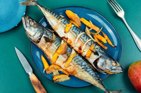 Photo for Appetizing mackerel fish roasted with mango. Baked whole fish. Top view. - Royalty Free Image