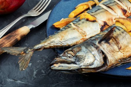 Photo for Two appetizing mackerel fish roasted with mango - Royalty Free Image