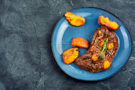 Photo for Diet baked beef steak with peach. American cuisine. - Royalty Free Image