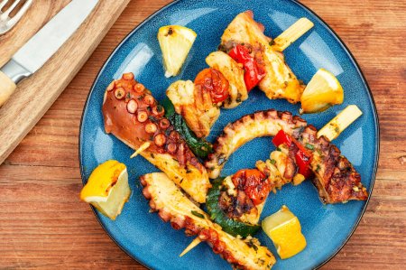 Photo for Grilled octopus on wooden skewers, grilled octopus. - Royalty Free Image