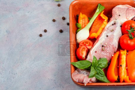 Photo for Fresh pork tenderloin with vegetables in a baking dish. Uncooked meat. Space for text - Royalty Free Image
